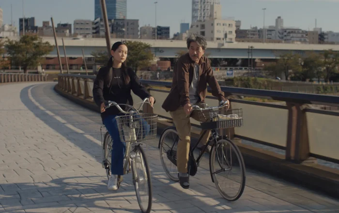 A man and a girl riding their bikes in the daytime